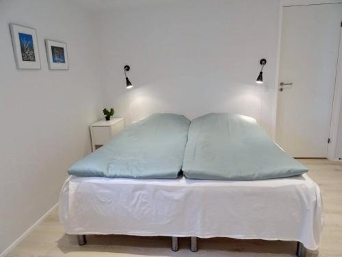 a bed with two pillows on it in a room at New, modern apartment near the centre of Tórshavn in Tórshavn
