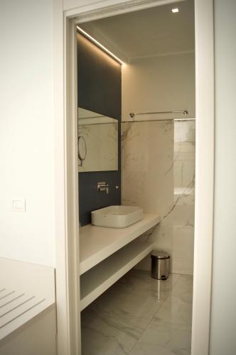 a bathroom with a sink and a mirror at Hotel Boutique Castiglione del Lago in Castiglione del Lago
