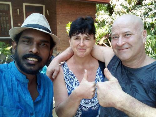 two men standing next to each other with their thumb up at So-J Beach Villa in Trincomalee