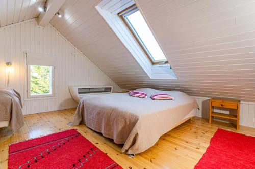 a bedroom with a large bed in a attic at Rantakari Cottage in Kotka