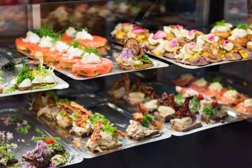 a display of different types of food on trays at Perfect Apartments in Superb Location by Strøget, the Metro & Attractions in Copenhagen