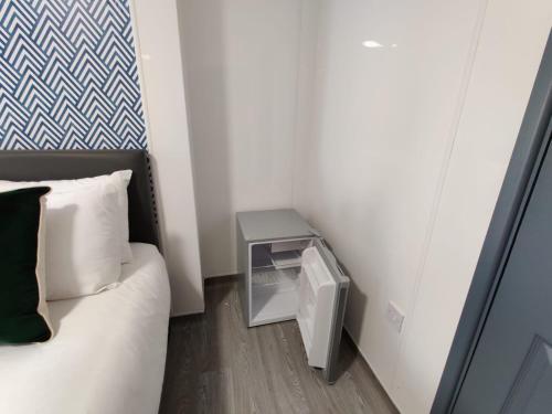 a room with a bed and a side table at Double Ensuite Rooms in Swansea