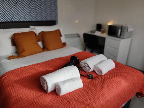 a bedroom with a bed with towels on it at Double Ensuite Rooms in Swansea