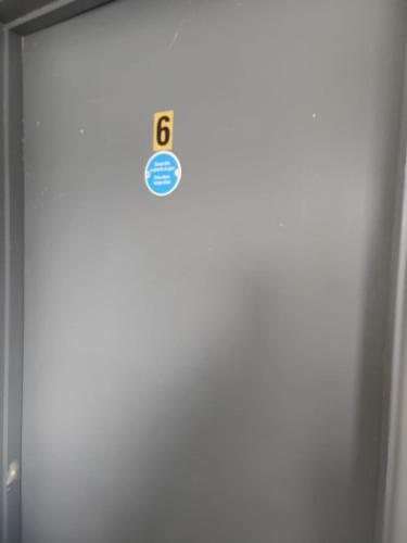 a door with a sign on the side of it at Double Ensuite Rooms in Swansea