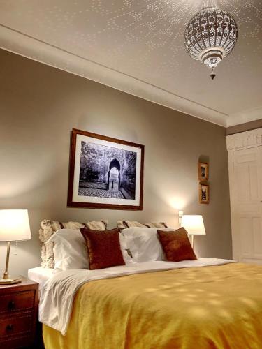 a bedroom with a large bed and a chandelier at Riad Dar Chacha in Marrakech