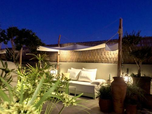 a white couch sitting on a patio at night at Riad Dar Chacha in Marrakech