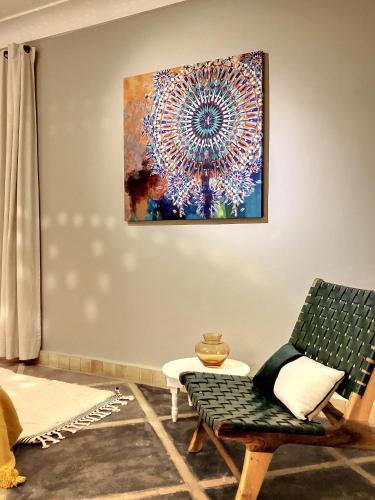 a living room with a painting on the wall at Riad Dar Chacha in Marrakech