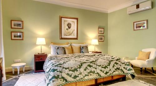 a bedroom with a bed and two lamps and a chair at Riad Dar Chacha in Marrakech