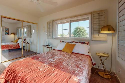 a bedroom with a large bed and a window at Sunset Disco: Large Pool/Spa @ Lush Family Retreat in La Quinta