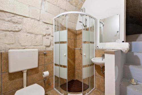 a bathroom with a glass shower and a sink at Suite dei Longobardi in Lecce