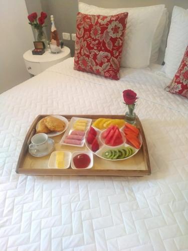 a tray of food on top of a bed at Adamas House Hotel Boutique in Quito
