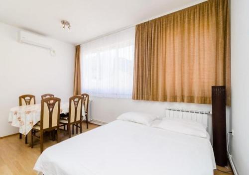 a bedroom with a bed and a table and chairs at House Lopin in Žuljana