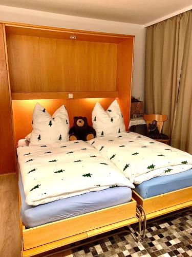 a bedroom with two beds with a teddy bear on them at FeWo Fuchs Saig in Lenzkirch