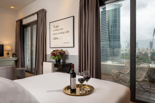 a hotel room with a bottle of wine on a table at Hotel Indigo Tel Aviv - Diamond District by IHG in Tel Aviv