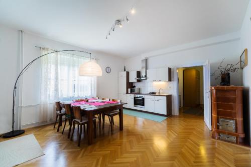 a kitchen and dining room with a table and chairs at Soska 5 in Ljubljana