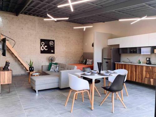 a kitchen and a living room with a table and chairs at La Terraza Home in Guadalajara