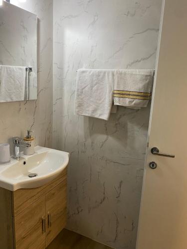 a white bathroom with a sink and a mirror at Ristorante Del Ponte in Cugnasco