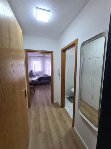 a room with a hallway with a mirror and a door at South Apartment - Modern & Stylish in Augsburg