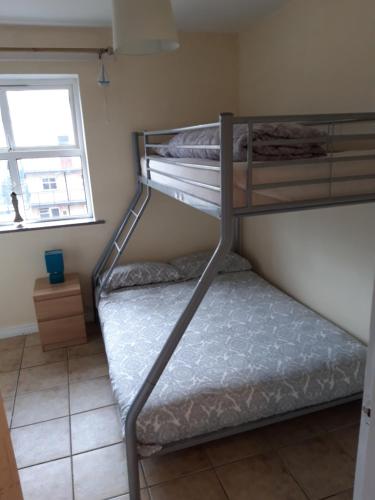two bunk beds in a room with a window at Beautiful Seaview Penthouse Apartment in Bundoran