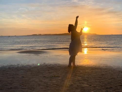 a woman standing on the beach at sunset at Green Life Full Amenities in Punta del Este