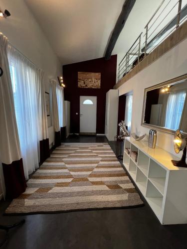 a hallway with a large rug on the floor at BLB Loft Luxury House in Villenave-dʼOrnon