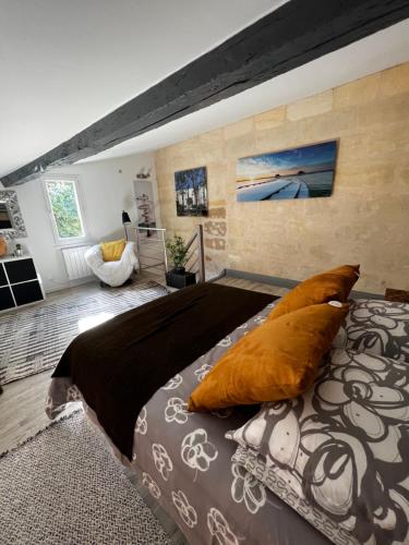 a bedroom with a large bed with orange pillows at BLB Loft Luxury House in Villenave-dʼOrnon