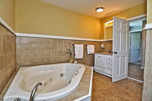 a large bathroom with a tub and a sink at Charming Cottage Historic Falmouth Cape Cod Near Beach and Downtown 2BR 1Bath Deck in Falmouth