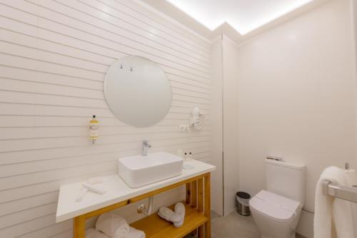 a white bathroom with a sink and a toilet at Hotel Boutique Sibarys - Adults Recommended in Nerja
