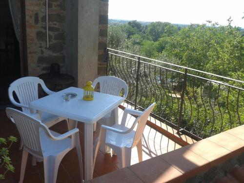 a white table and chairs on a balcony at Le Mimose B&B in Vinci
