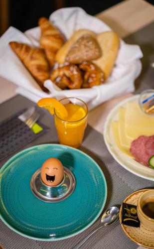 a table with an egg on a plate with bread at Hotel Stachus in Munich