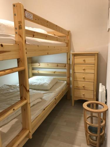 a bedroom with two bunk beds and a dresser at T2 +alcove, récent 4/5 pers. Parking. Balcon. Wifi in Cauterets