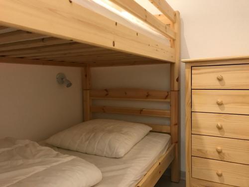 a bedroom with two bunk beds and a dresser at T2 +alcove, récent 4/5 pers. Parking. Balcon. Wifi in Cauterets