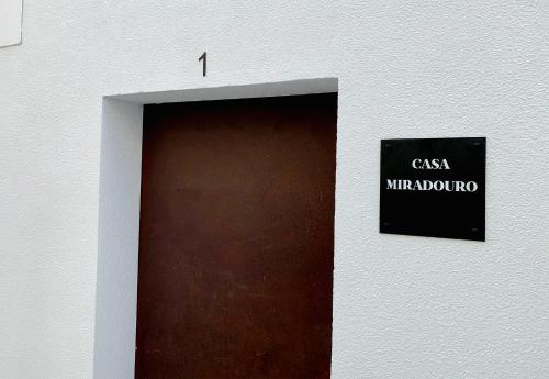 a door in a building with a sign on it at Casa Miradouro Apartments in Setúbal