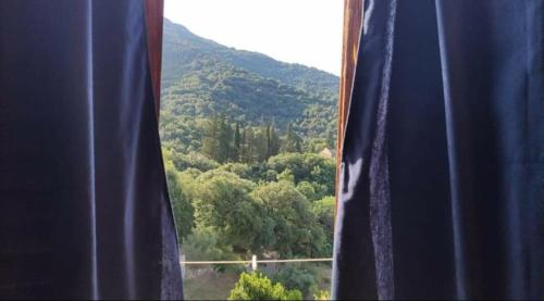 a window with a view of a mountain at Sa Dommu 'e su coro in Triei