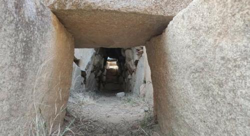 an entrance to a cave in a rock formation at Sa Dommu 'e su coro in Triei
