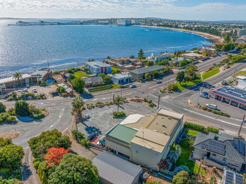 an aerial view of a city and the ocean at Navigators Motel in Port Lincoln