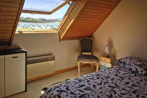 une chambre avec un lit, une chaise et une fenêtre dans l'établissement Apartment in Portsall with Stunning Sea View, à Ploudalmézeau