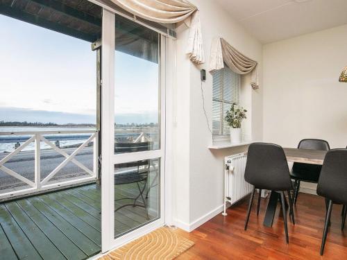 a dining room with a table and a view of the ocean at 8 person holiday home in Hals-By Traum in Hals