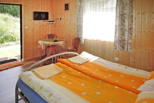 a bedroom with two beds and a table and a window at Holiday resort, Wiselka in Wisełka