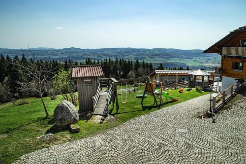 a playground with a rock and a swing at Holiday Home in Neureichenau near Bavarian Forest in Neureichenau