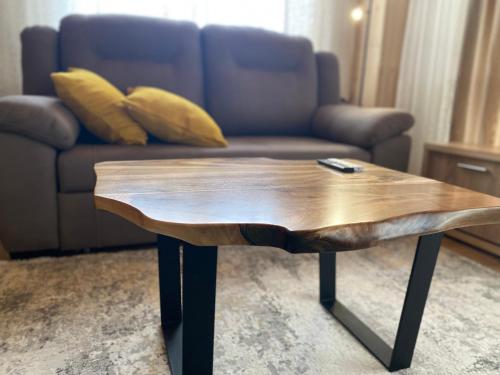 a wooden coffee table in a living room with a couch at Високий Перевал, Bukovel in Yablunytsya