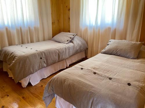Säng eller sängar i ett rum på Cabañas Kuela