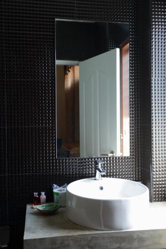a bathroom with a white sink and a mirror at ฮักเคียงโขง HUG Khieng Khong Nongkhai Hostel in Nong Khai