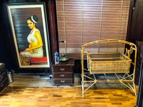 a room with a painting of a woman in a window at Castillo De Woods , The Private Luxury Villa , 8 BHK, Vattavada in Kottakamboor