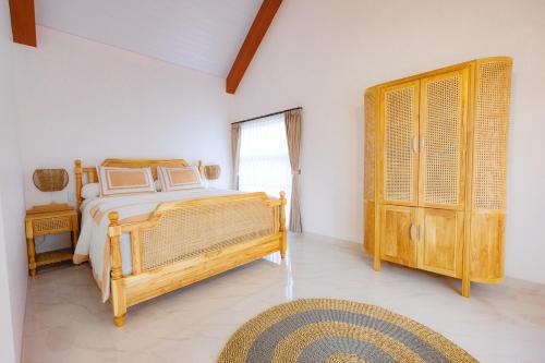 Кровать или кровати в номере Villa Ruang Rindu Malioboro