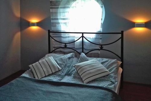 a bedroom with a bed with two pillows and a window at Bungalow, Bieszkowice in Bieszkowice