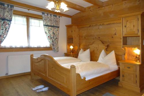 a bedroom with a large bed in a wooden room at Chalet Rabl, Westendorf in Westendorf