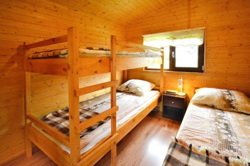 a bedroom with two bunk beds in a log cabin at Holiday homes, Rusinowo in Rusinowo