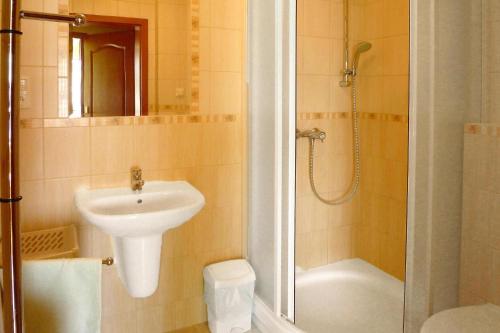 a bathroom with a sink and a toilet and a shower at Semi-detached house, Rowy in Rowy