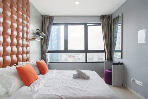 a bedroom with a large bed with orange pillows and a window at iCity 1Bedroom Apt Near Mall FREE PARKING & WIFI in Shah Alam